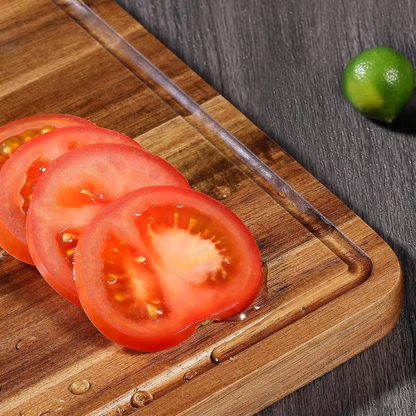 Sliced tomatoes on a wooden cutting board with a lime in the background